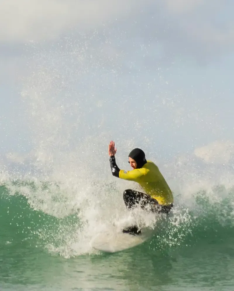 Surfer getting low with white water popping up either side of them