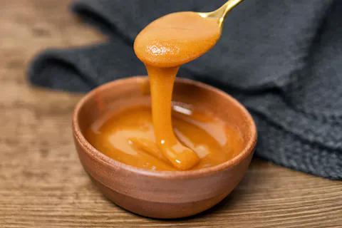 Manuka Honey being drizzled