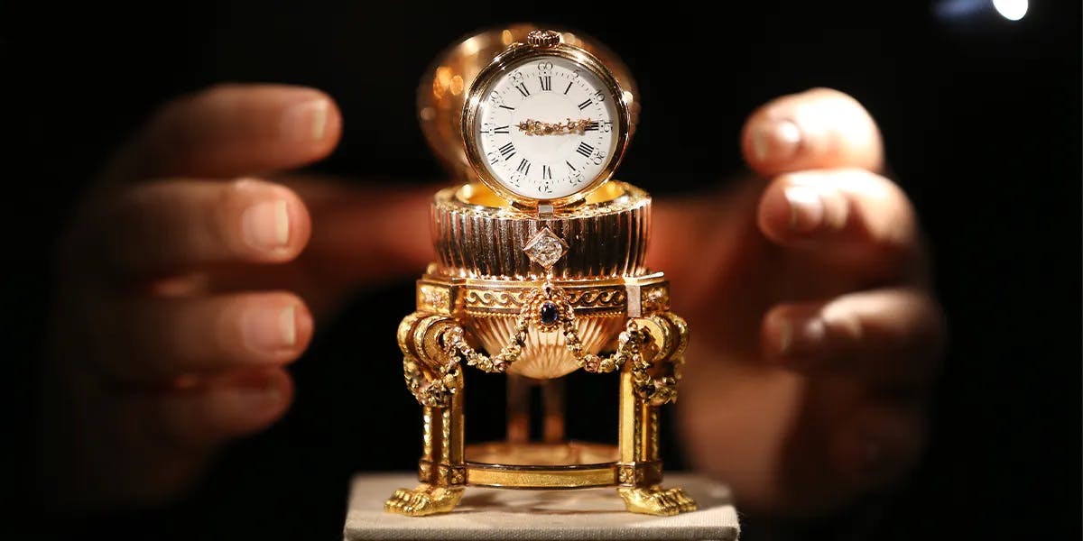 LONDON, ENGLAND - APRIL 16: The Third Imperial Fabergé Easter Egg is displayed at Royal Jeweler Wartski on April 16, 2014 in London, England. This rare Imperial Fabergé Easter egg, made for the Russian Imperial family in 1887 and said to be worth tens of millions of dollars, was confiscated by the Bolsheviks after the Russian Revolution. In 1964 it was auctioned in New York as a “Goldwatch in Egg Form Case” for $2,450 – its origin was unknown at the time. Later, a buyer in the US Midwest bought it for what was believed to be scrap metal value until he discovered its true value. (Photo by Peter Macdiarmid/Getty Images) (detail)
