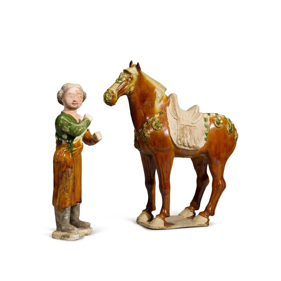 A sandal-glazed figure of a caparisoned horse and a groom, Tang Dynasty. Image © Sotheby’s London