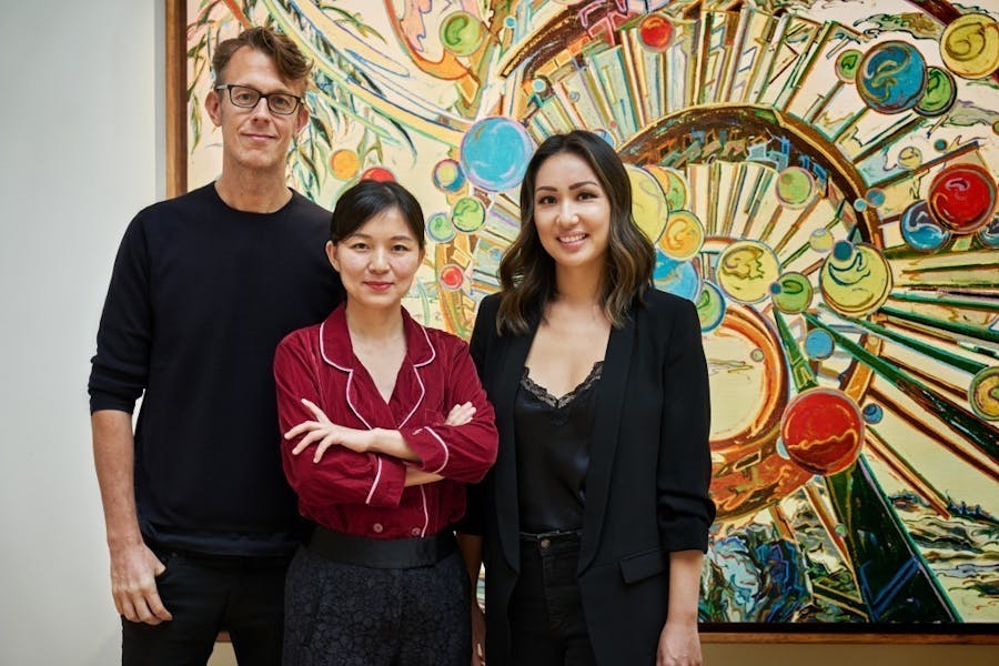 CFHILL's Michael Elmenbeck together with 'Mountains &amp; Streams' curators Shi Zheng and Melanie Lum in front of a work by You Jin