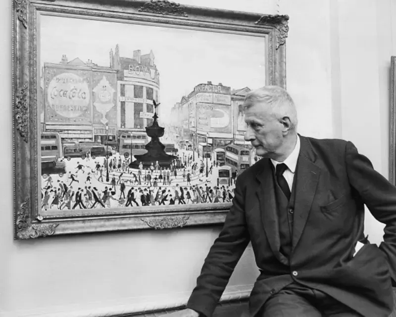 L'artiste anglais L. S. Lowry (1887 - 1976) avec son tableau "Piccadilly Circus" lors d'une exposition de ses dernières œuvres aux Lefevre Galleries à Londres, le 11 octobre 1961. (Photo par Ron Case/Keystone/Hulton Archive/Getty Images)