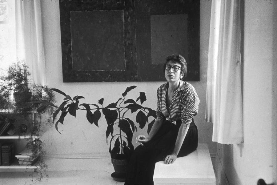 Abstract Expressionist artist Lee Krasner (1908 - 1984), the wife of artist Jackson Pollock, seated on a ledge at her home in East Hampton, New York. Photo by Tony Vaccaro/Hulton Archive/Getty Images