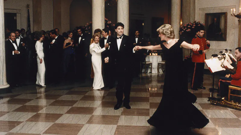 John Travolta twirls Princess Diana on the dance floor while at a White House banquet. Ronald and Nancy Reagan can be seen in the background. (Photo by © Pool Photograph/Corbis/Corbis via Getty Images)