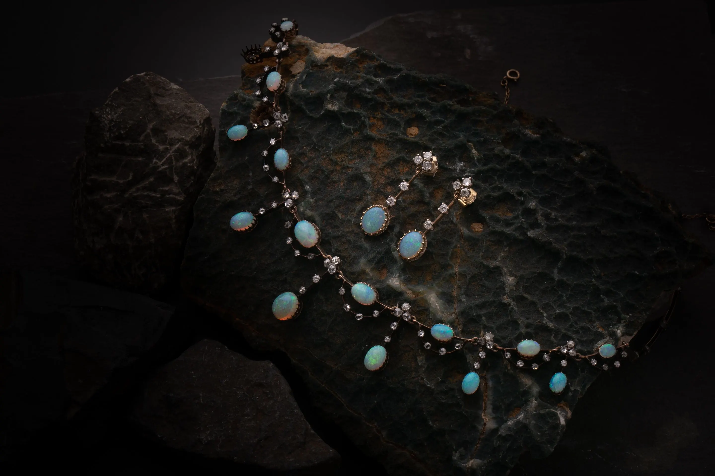 An Edwardian opal and diamond fringe necklace, in original case, together with a pair of associated opal and diamond ear pendants. Photo © Dawsons Auctioneers
