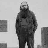 American artist and sculptor Carl Andre pictured at the Whitechapel Gallery in London on March 15, 1978. (Photo by Evening Standard/Hulton Archive/Getty Images)(detail)
