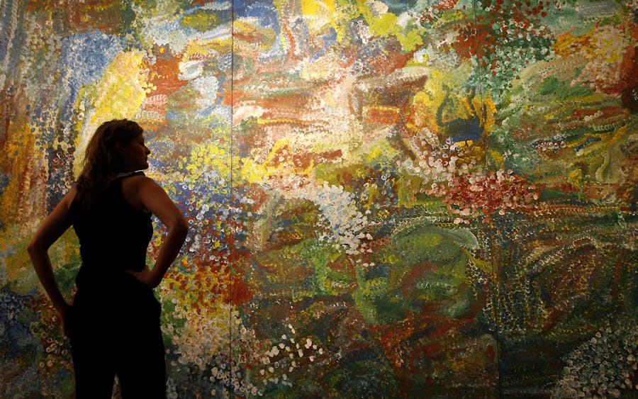 Art lover Vyvyan Hammond admires Emily Kame Kngwarreye's masterpiece 'Earth's Creation' before the start of the Lawson-Menzies auction of Aboriginal fine art in Sydney, 23 May 2007. Photo © TORSTEN BLACKWOOD/AFP via Getty Images