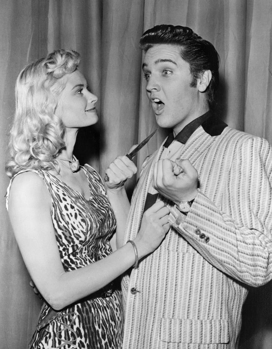Actress Irish McCalla playfully threatens Elvis Presley with a knife while on The Milton Berle Show. He is wearing his 44 diamond encrusted, manual-wound, Caliber 510 Omega watch. Photo: Bettmann/CORBIS/Bettmann Archive