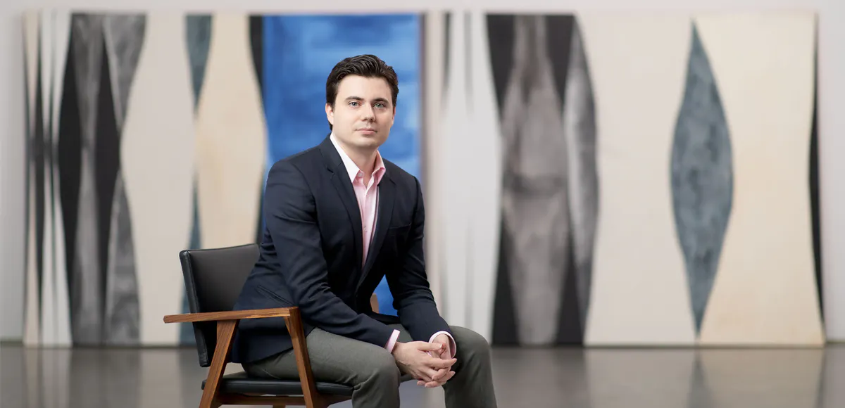 Joan Robledo-Palop, Zeit Contemporary Art Founder and CEO, sitting in front of a work by American artist Julia Rooney. Photograph by Marcin J. Muchalski