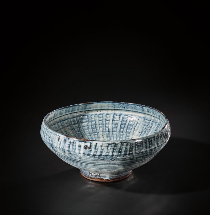  Michael Cardew, Bowl with ‘Basket’ pattern, circa 1955. Stoneware, vivid blue and white over iron glazes, with a finger wipe design beneath the glaze inside and out. Photo © PHILLIPS