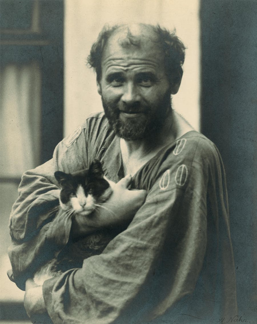  Gustav Klimt, in his arms holding one of his cats, in front of his studio in Vienna, 8th district, Josefstaedter Strasse 21. Photography by Moriz Naehr around 1912. (Photo by Imagno/Getty Images)