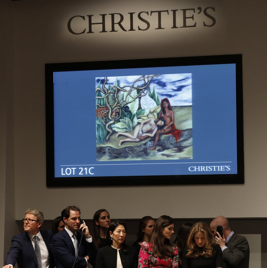 Frida Kahlo's &quot;Two Nudes in the Woods,&quot; is displayed on a video screen as workers take bids for the painting during Christie's Impressionist and Modern Art spring sale Thursday, May 12, 2016, in New York. The Kahlo painting broke the world auction record for the artist, as well as for any Latin American artist sold at auction. (AP Photo/Kathy Willens)