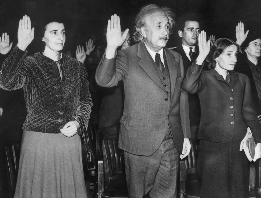Einstein takes the oath of U.S. citizenship with his daughter and his secretary in 1940. Photo © American Stock/Getty Images
