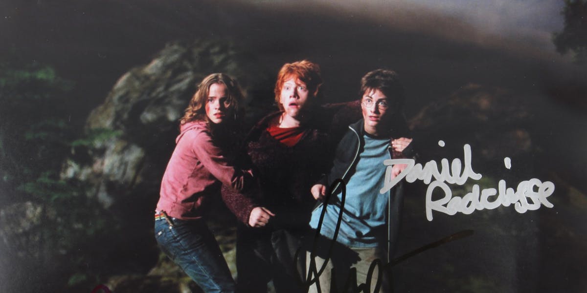 Harry Potter - Colour photograph signed by Daniel Radcliffe, Emma Watson and Rupert Grint, 10 x 8 inches. Photo © Ewbank's (detail)
