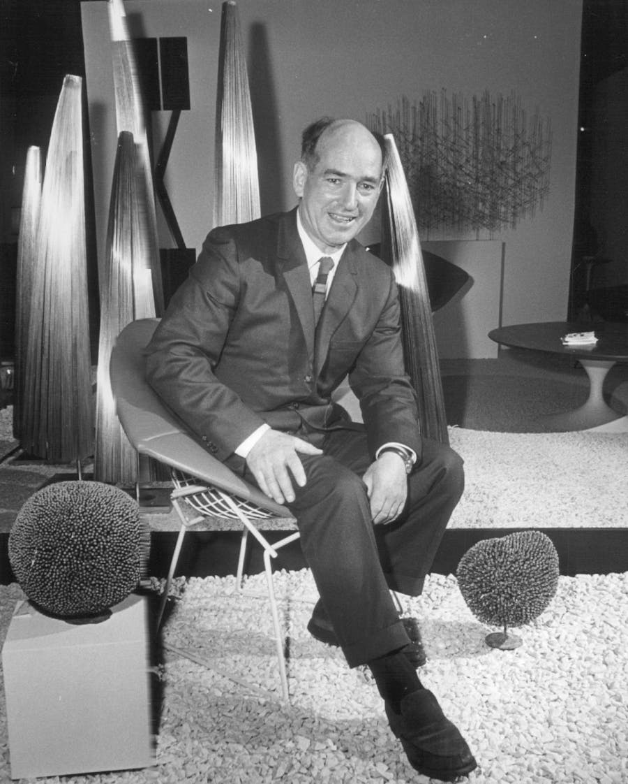 MAY 29 1966, Harry Bertoia Sits In One Of His Chairs Near His Sculpture. "A chair is designed as much by one's behind as one's head," said the Pennsylvanian. Credit: Denver Post (Denver Post via Getty Images)