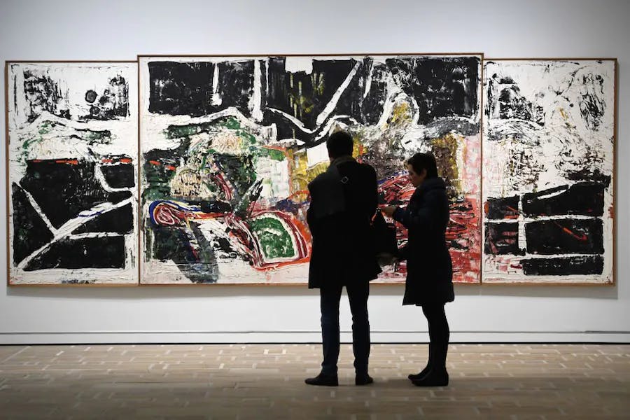 People contemplate an oil painting "From the Great Whale" (1973) by Canadian Jean-Paul Riopelle during the exhibition "Mitchell-Riopelle, Nothing in moderation" at the Hélène and Edouard Fund Leclerc in Landerneau, western France, on December 18, 2018. – The exhibition "Mitchell-Riopelle, Nothing in moderation" (A couple in excess) is held from December 16, 2018 to April 22, 2019. (Photo FRED TANNEAU/AFP via Getty Images ).