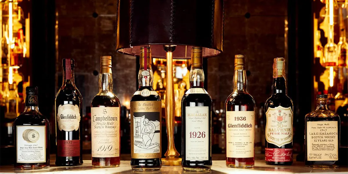 Bottle photos LR Ardbeg 1967 Signatory Vintage 30 Year Old / Dark Oloroso Butt # 578, Glenfiddich 1937 Rare Collection 64 Year Old, Springbank 1919 50 Year Old, The Macallan 1926 Valerio Adami 60 Year Old, The Macallan 1926 Fine and Rare 60 Year Old 75cl / US Import, Glenfiddich 1936 Peter J Russell, The Balvenie 1937 Pure Malt 50 Year Old 75cl / Milroy's of Soho, Bowmore 1967 Largiemeanoch 12 Year Old [detail]. Photo © Peter Dibdin Photography, location: Gleneagles Hotel American Bar