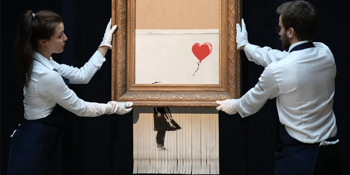 LONDON, ENGLAND - OCTOBER 12: Sotheby's unveils Banksy's re-titled "Love is in the Bin" on October 12, 2018 at Sotheby's in London, England. The canvas work, originally entitled "Girl with Balloon", rattled through a hidden document shredder seconds after the hammer blow at the Contemporary Art Evening Sale at Sotheby's London on October 5, 2018, making it the first work of art in history to be created live during an auction. (Photo by Tristan Fewings / Getty Images for Sotheby's)