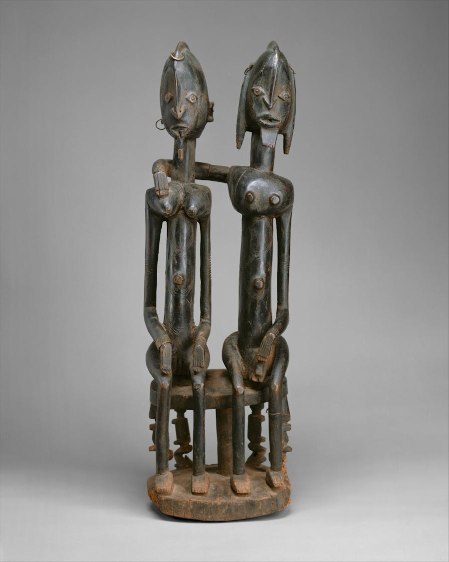 Dogon figure: seated couple, 18th-early 19th century, Mali, wood and metal. Public domain image