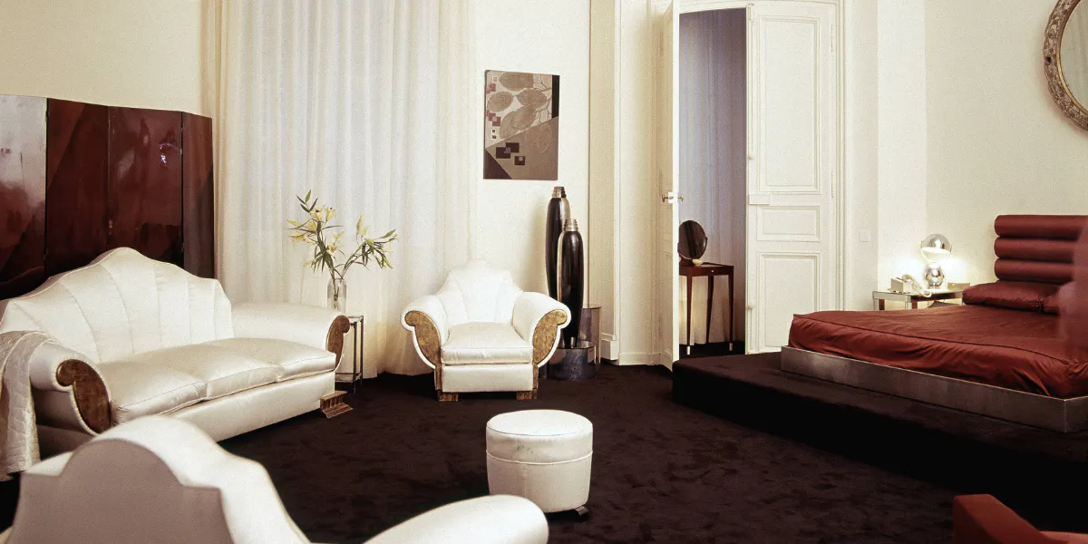 Karl Lagerfeld's Paris apartment with Eileen Grey screen, Dunand painting and vases, and sofa and chairs from a house decorated by Elsie de Wolfe (Lady Mendl). September, 1974. Photo by Horst P. Horst/Conde Nast via Getty Images.