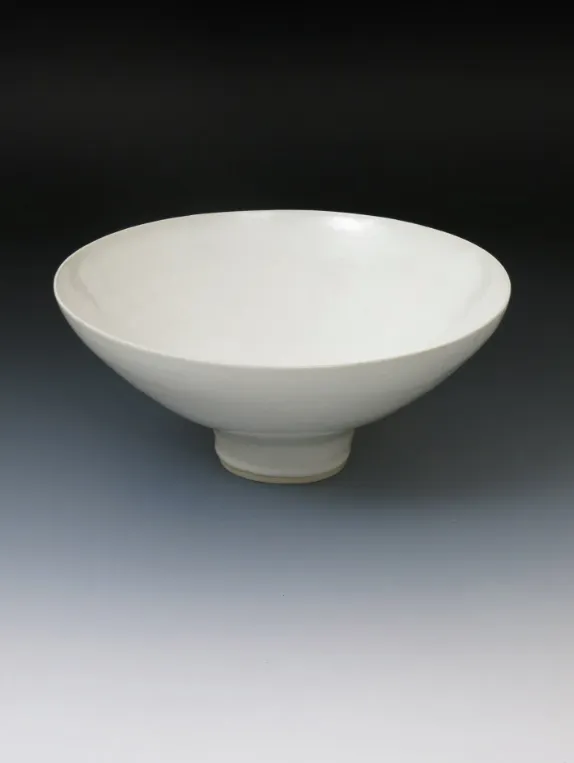 Dame Lucie Rie DBE (1902-1995) a large flaring porcelain bowl, covered to the foot with a gloss white glaze, impressed marksEstimate: £4,000 - 6,000