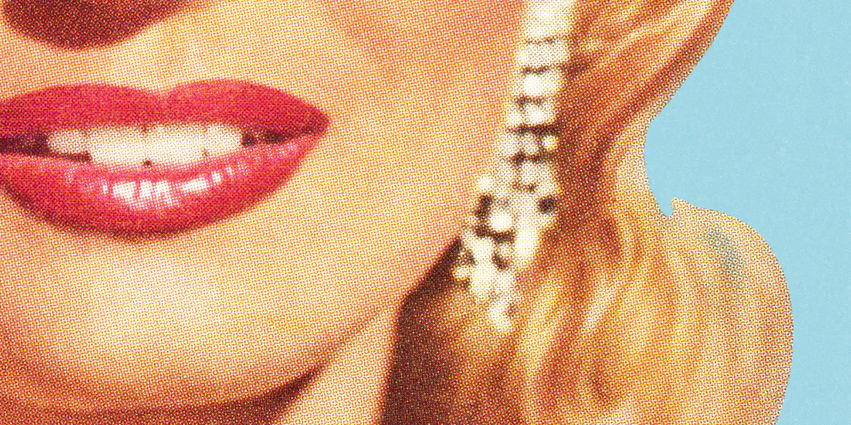 Close up of a woman's face with earrings. (Photo via Getty Images)