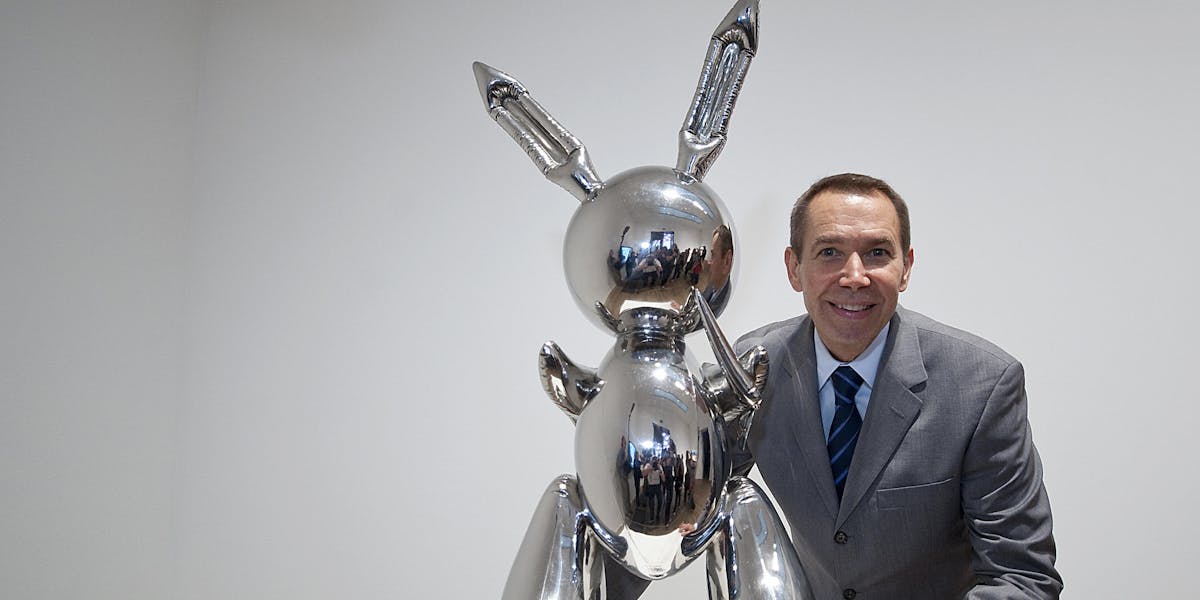 US artist Jeff Koons poses for photographs with his work of art entitled 'Rabbit 1986' during the press view of the 'Pop Life, Art In A Material World' exhibition at the Tate Modern, in London, on September 29, 2009. Photo: BEN STANSALL/AFP via Getty Images