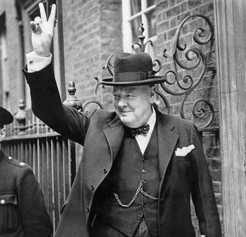 Former UK Prime Minister Winston Churchill makes the 'V' sign in Downing Street, London, wearing the distinctive Homburg hat. Photo taken 5 June 1943. Photo public domain