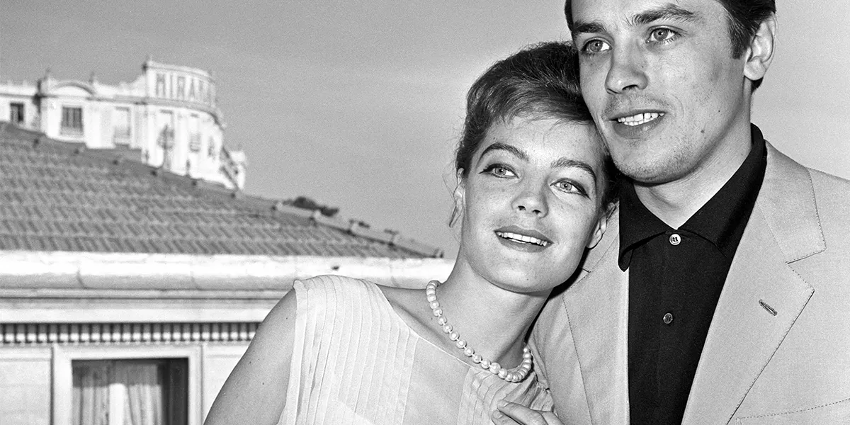 Alain Delon and Romy Schneider relax lovingly on a terrace in Cannes, where they are both guests of the festival (Photo by Daniel Fallot\INA via Getty Images) (detail)