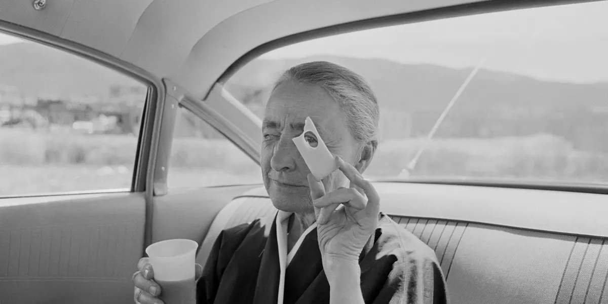 Die amerikanische Malerin Georgia O'Keeffe sitzt auf dem Rücksitz eines Autos und blickt durch ein Loch in einem Stück Schweizer Käse, Taos Pueblo, New Mexico 1960 (Foto: Tony Vaccaro/Getty Images)(Detail)