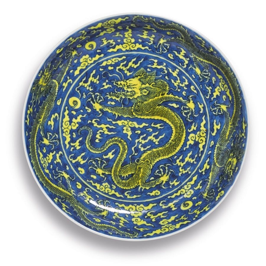 A fine yellow-enamelled blue-ground ‘dragon’ dish, Kangxi mark and period (1662-1722). Image © Sotheby’s 