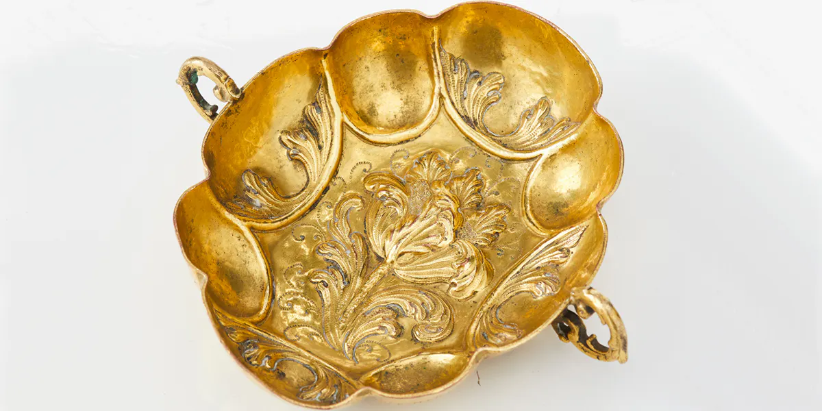 A baroque Herrengrund late 17th/early 18th century embossed gilt copper cup with inscription.