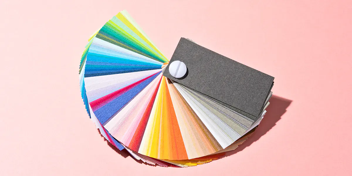 Bright color wheel, color scheme on pink peach background. MirageC via Getty Images