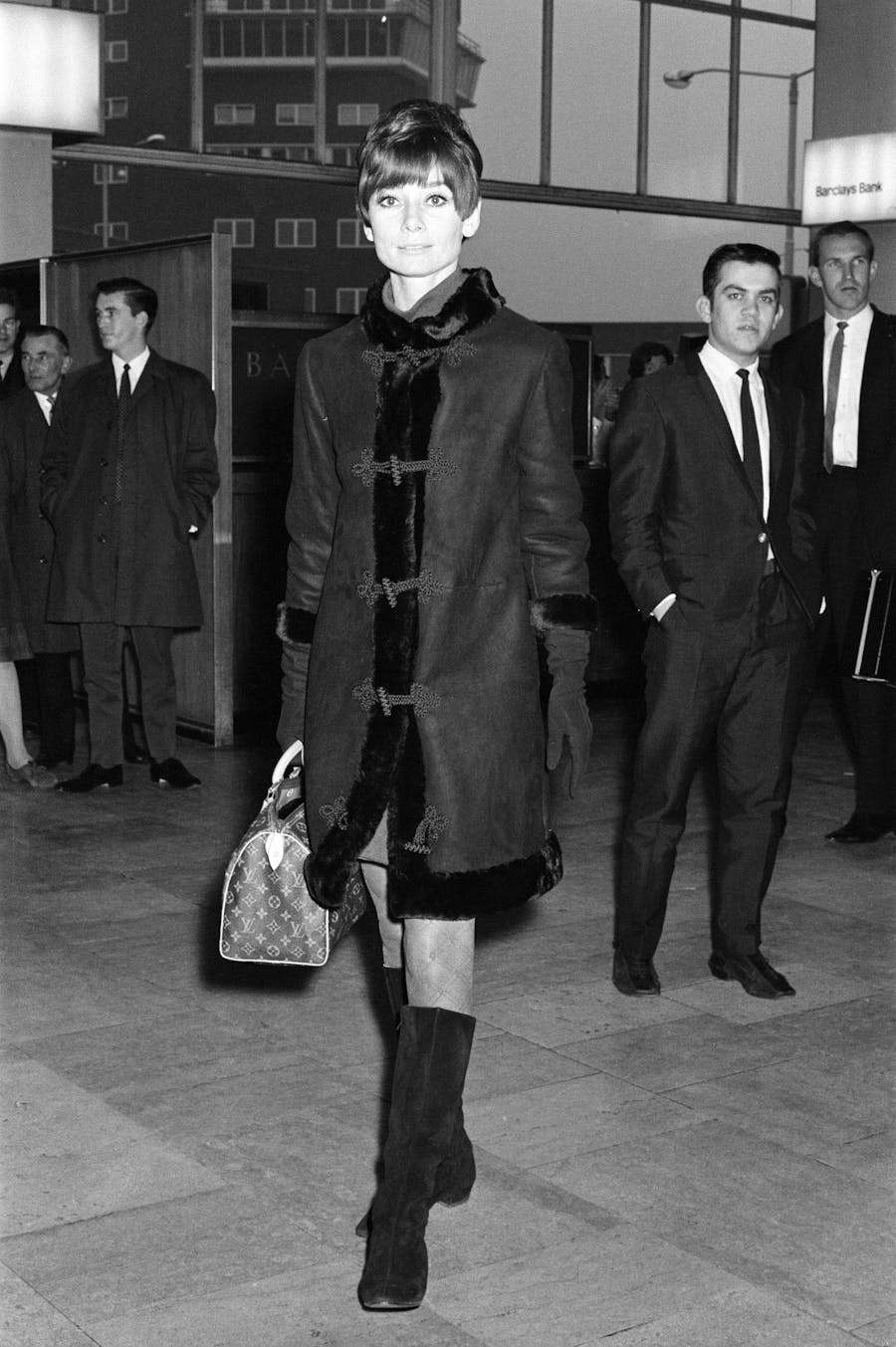 British actress Audrey Hepburn choosing a bag helped by the
