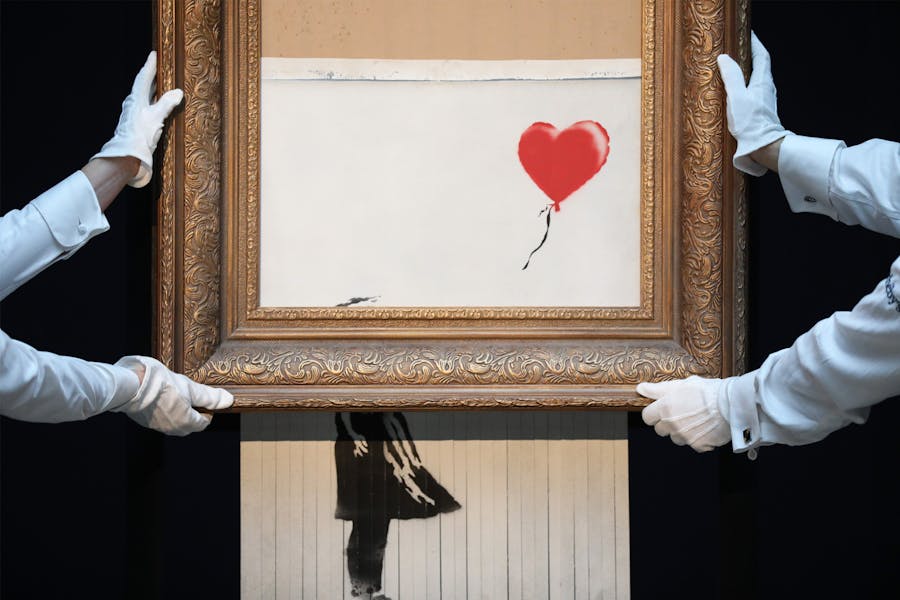 Sotheby’s unveils Banksy’s newly-titled ‘Love is in the Bin’ at Sotheby's on 12 October 2018 in London. Originally titled ‘Girl with Balloon’, the canvas passed through a hidden shredder seconds after the hammer fell at Sotheby’s London Contemporary Art Evening Sale on 5 October 2018, making it the first artwork in history to have been created live during an auction. Photo by Tristan Fewings via Getty Images for Sotheby's