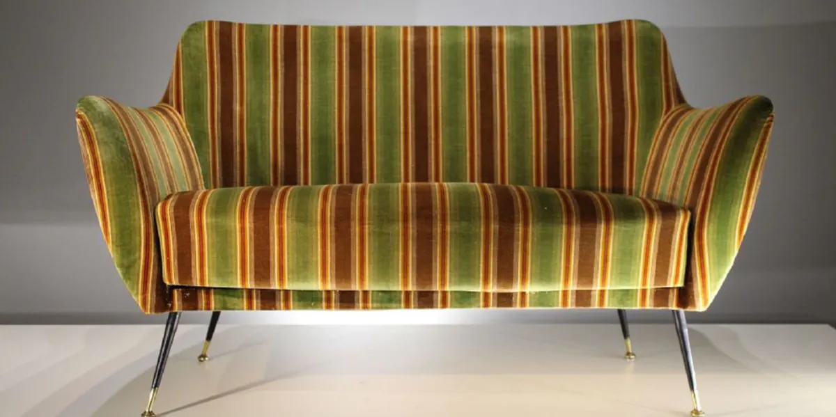 Two seat sofa, upholstered with metal legs and brass feet, 143 x 85 x 73 cm. Photo: deVeres Auctions
