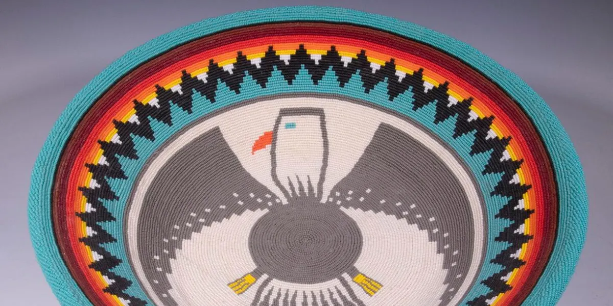 Spectacular large shallow basket decorated with decoration of the Morning Eagle on interior, Yei Be Chei Corn People. Image © Thomaston Place Auction Galleries (detail)