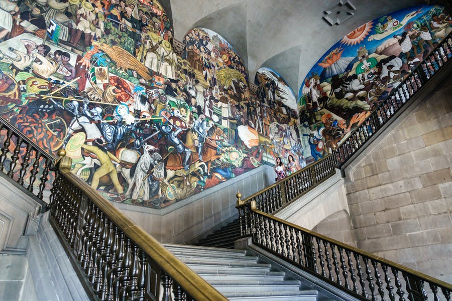 The central staircase of the Palacio Nacional in Mexico City. Photo by Jeffrey Greenberg / Universal Images Group via Getty Images