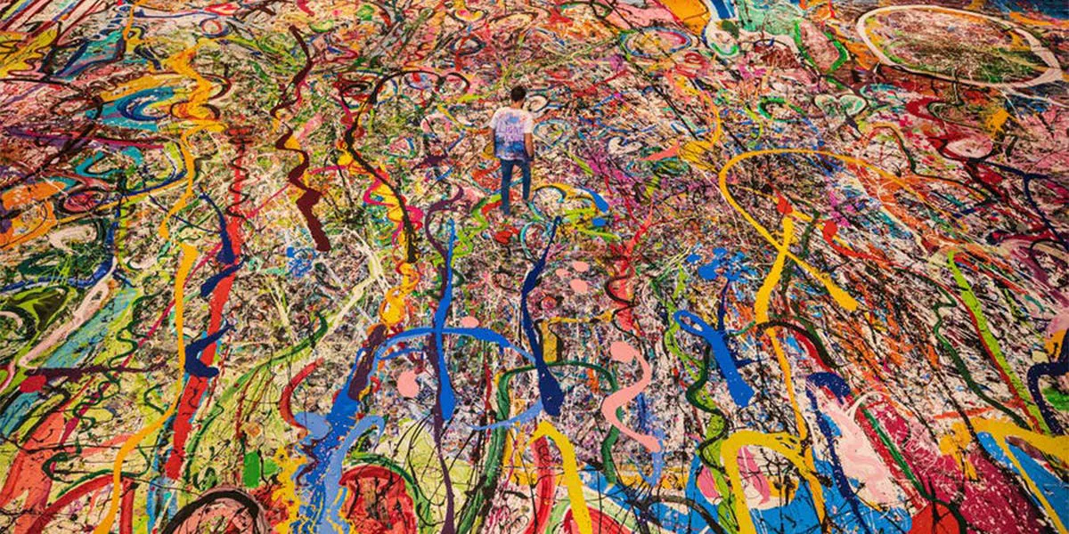 Sacha Jafri works on ‘The Journey of Humanity’, the largest canvas in the world, on 9 September 2020 in Dubai [detail] Photo: Francois Nel / Getty Images