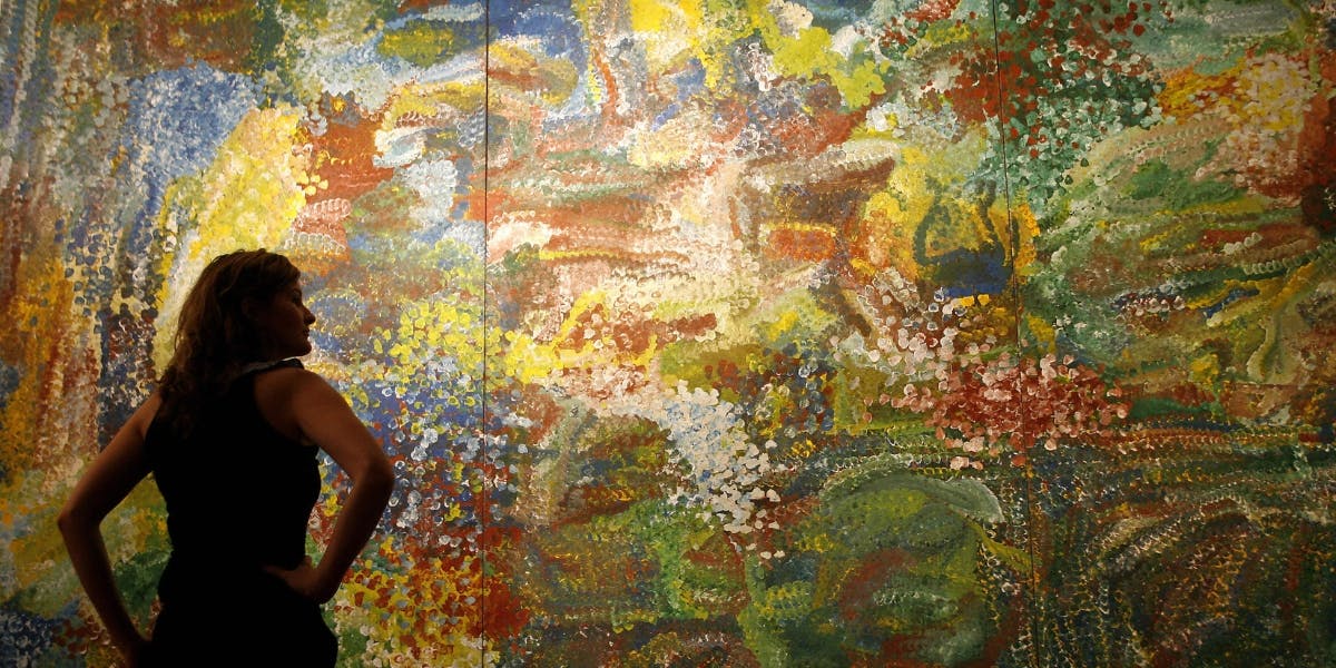 Art lover Vyvyan Hammond admires Emily Kame Kngwarreye's masterpiece 'Earth's Creation' before the start of the Lawson-Menzies auction of Aboriginal fine art in Sydney, 23 May 2007. Photo © TORSTEN BLACKWOOD/AFP via Getty Images (detail)