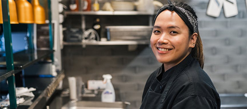 A chef smiling at the camera 