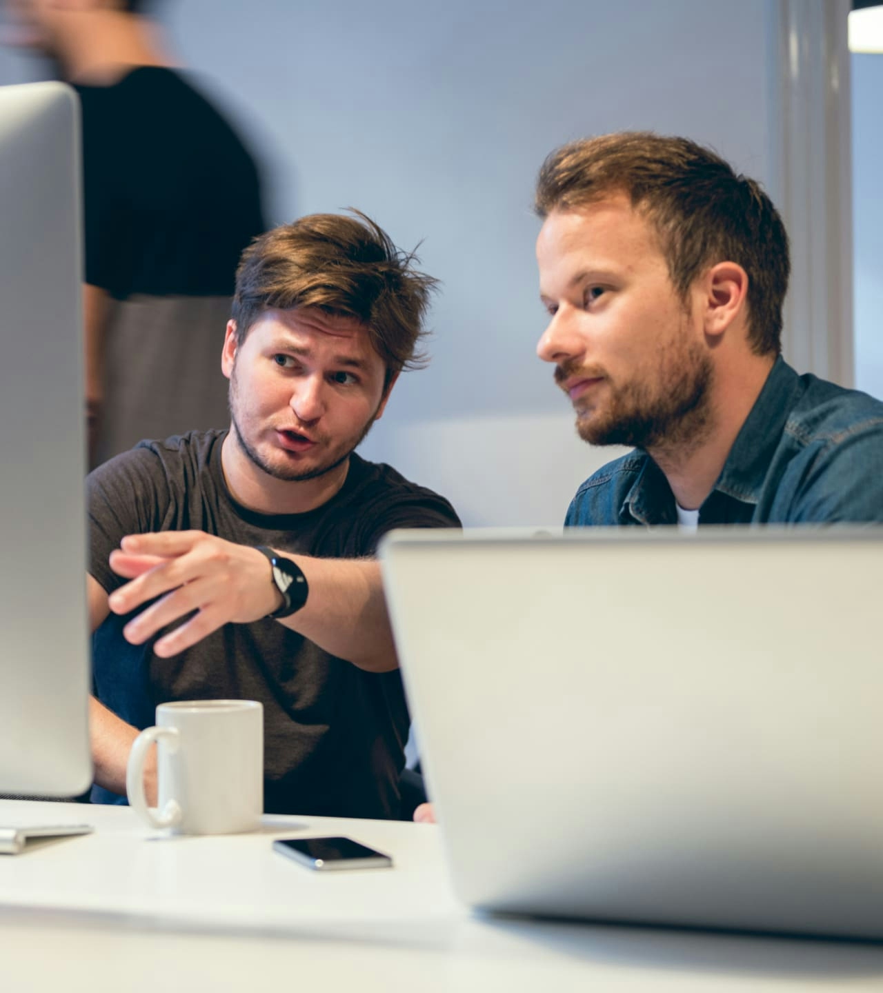 Two developers discussing about the code - hero image Two developers discussing about the code - hero image
