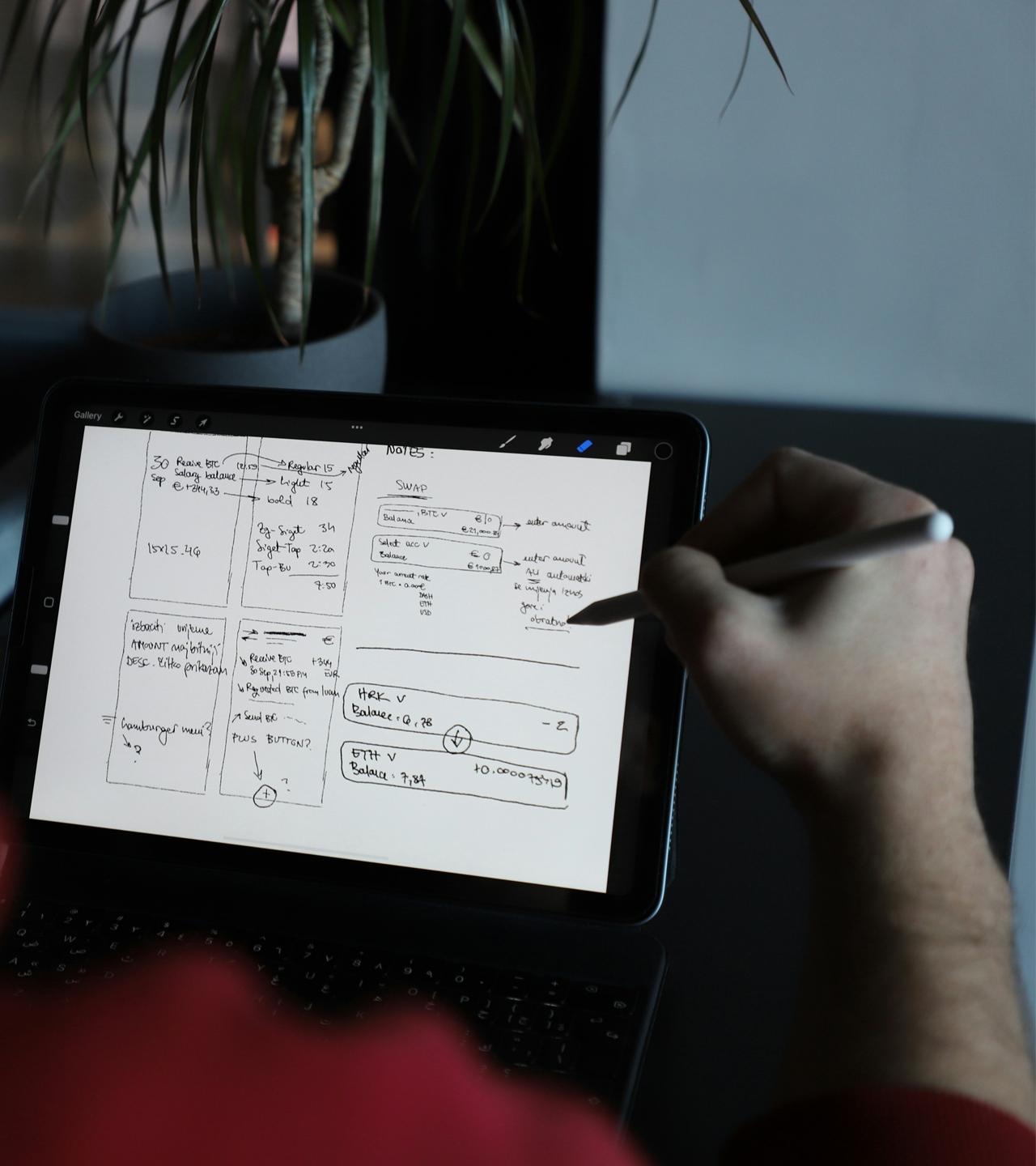 Designer holding a pen over a drawing tablet