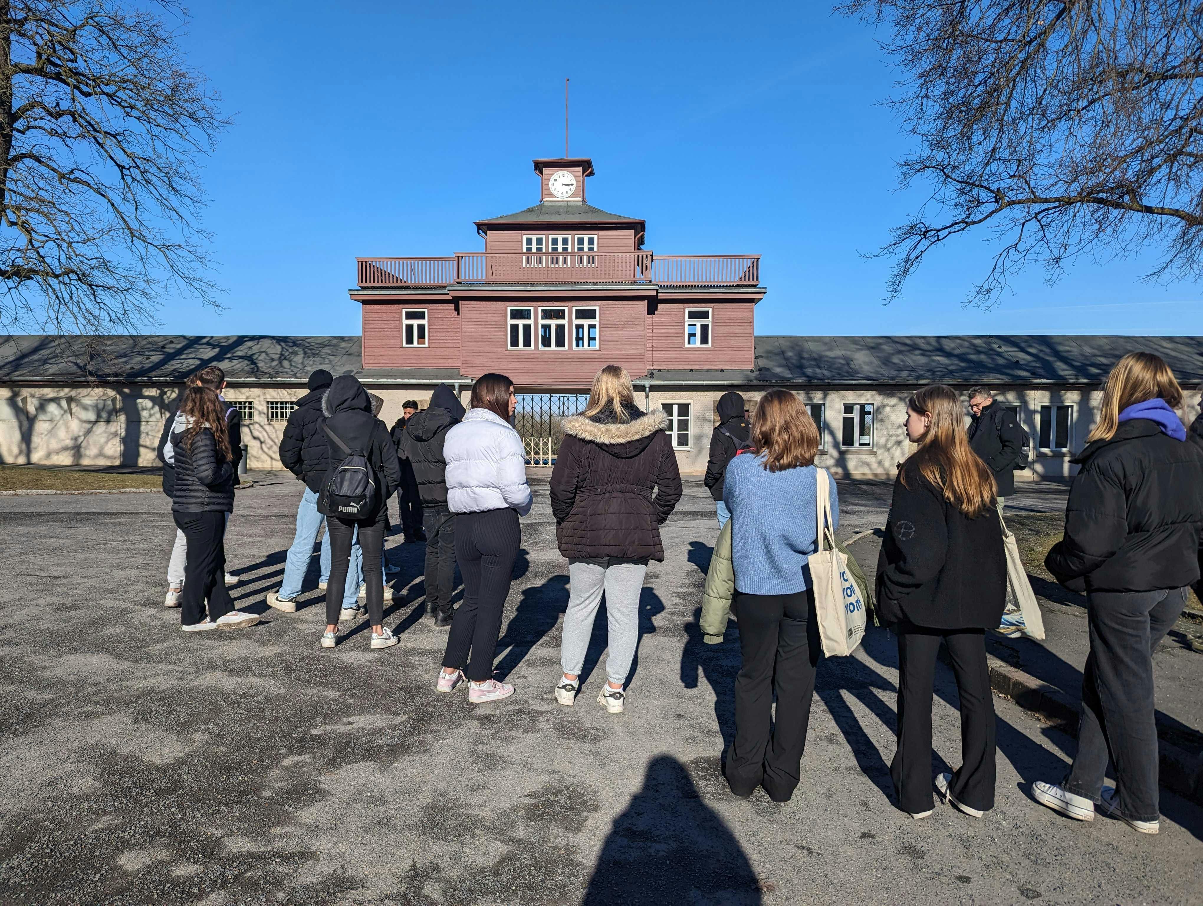 A group of young people in front of the entrance gate to the Buchenwald Memorial