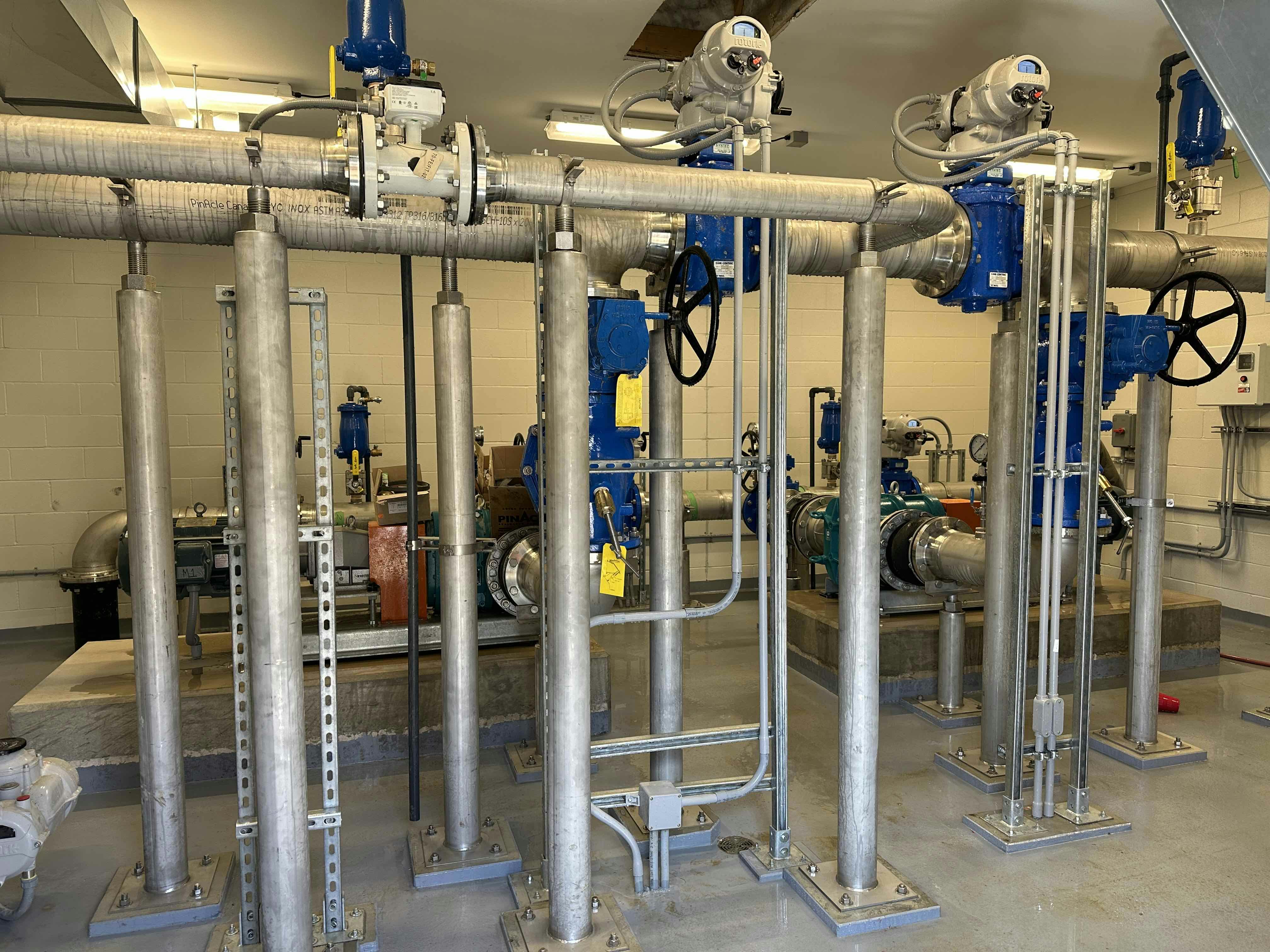 Interior of an industrial facility with metal pipes, valves, and machinery