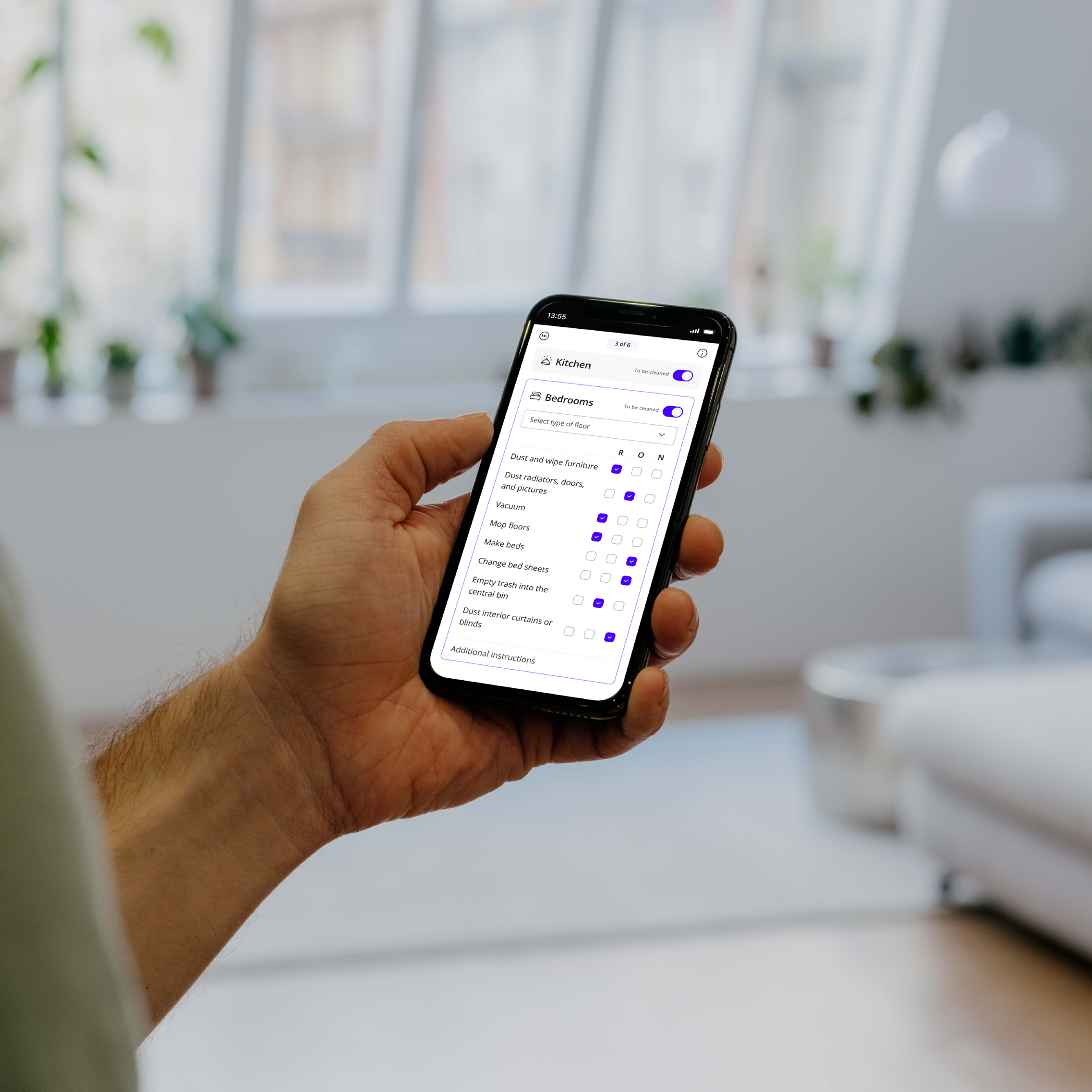 Person standing, engaged with Batmaid app displaying checklist feature.