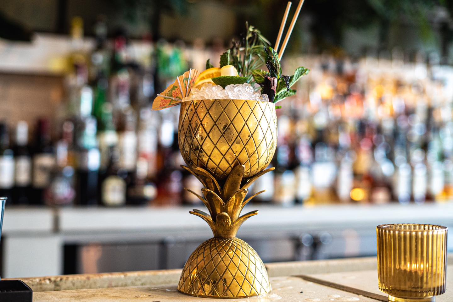 A bartender at The Public House in Bay City making a drink called "Birds in the Trap"