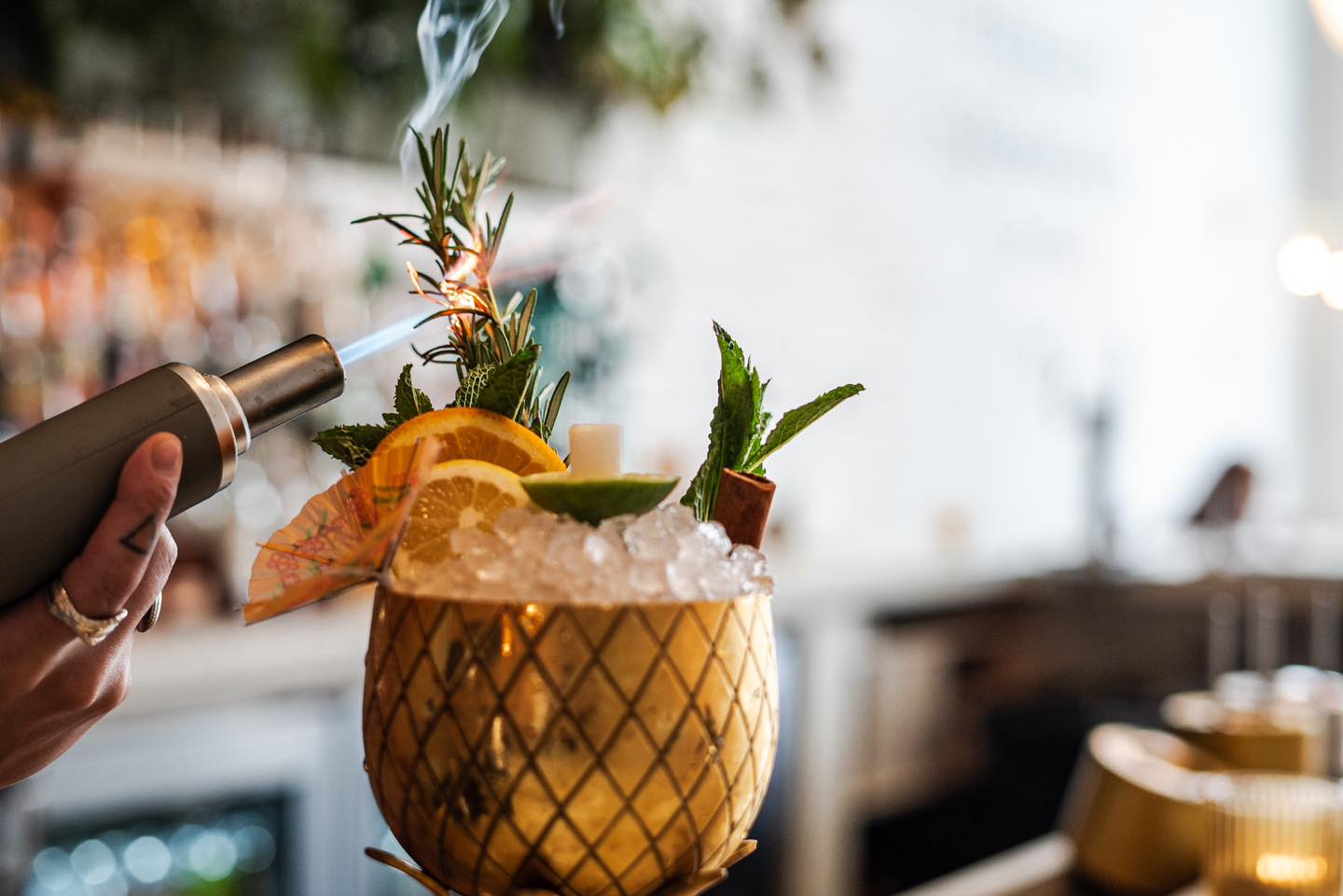 A bartender at The Public House in Bay City making a drink called "Birds in the Trap"