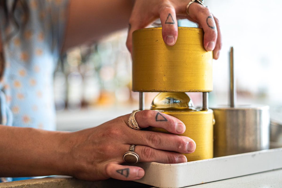 A bartender at The Public House in Bay City making a drink called "Moon Over Mexico"