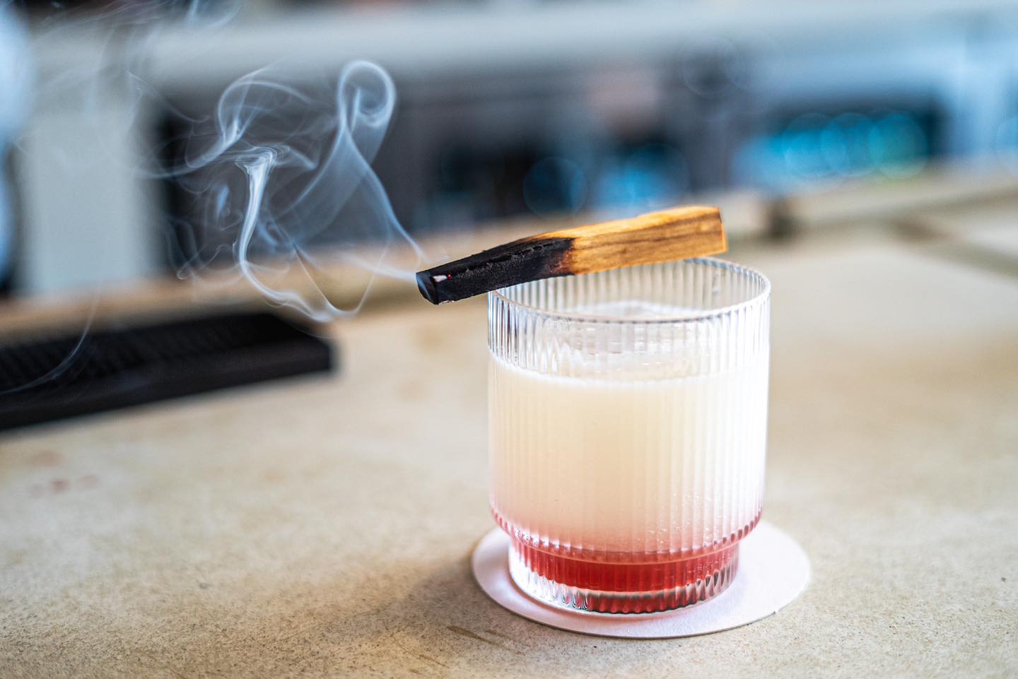 A bartender at The Public House in Bay City making a drink called "Ghost in the Machine"